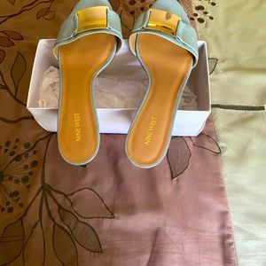 Woman’s Nine West light blue with gold buckle slide with heel.